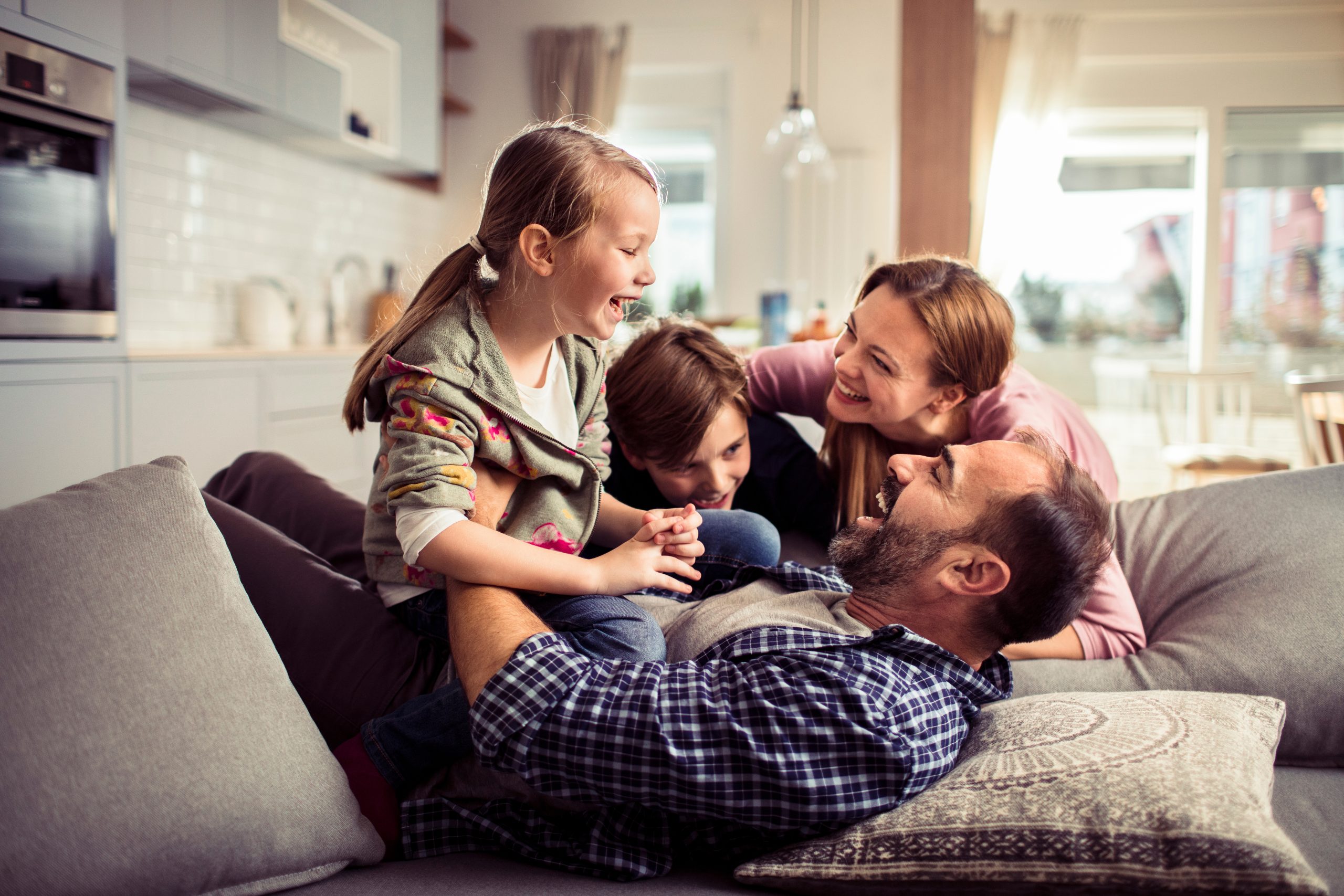 A family of four playing inside a Wye Cottage in Midland Ontario