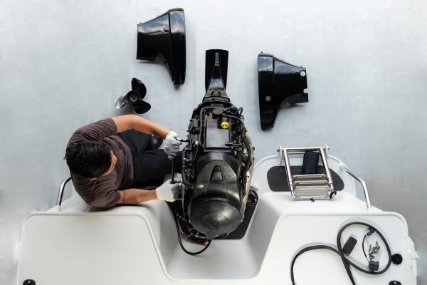 Service Technician working on lower unit of an outboard motor at Wye Heritage 