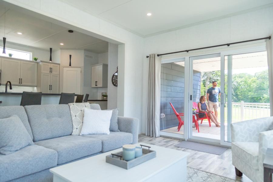 Living room looking out at patio at Wye Cottages Beausoliel model for sale in Midland Ontario